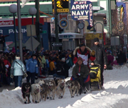 Musher heads down Fourth Avenue in Anchorage at the ceremonial start of the Iditarod.